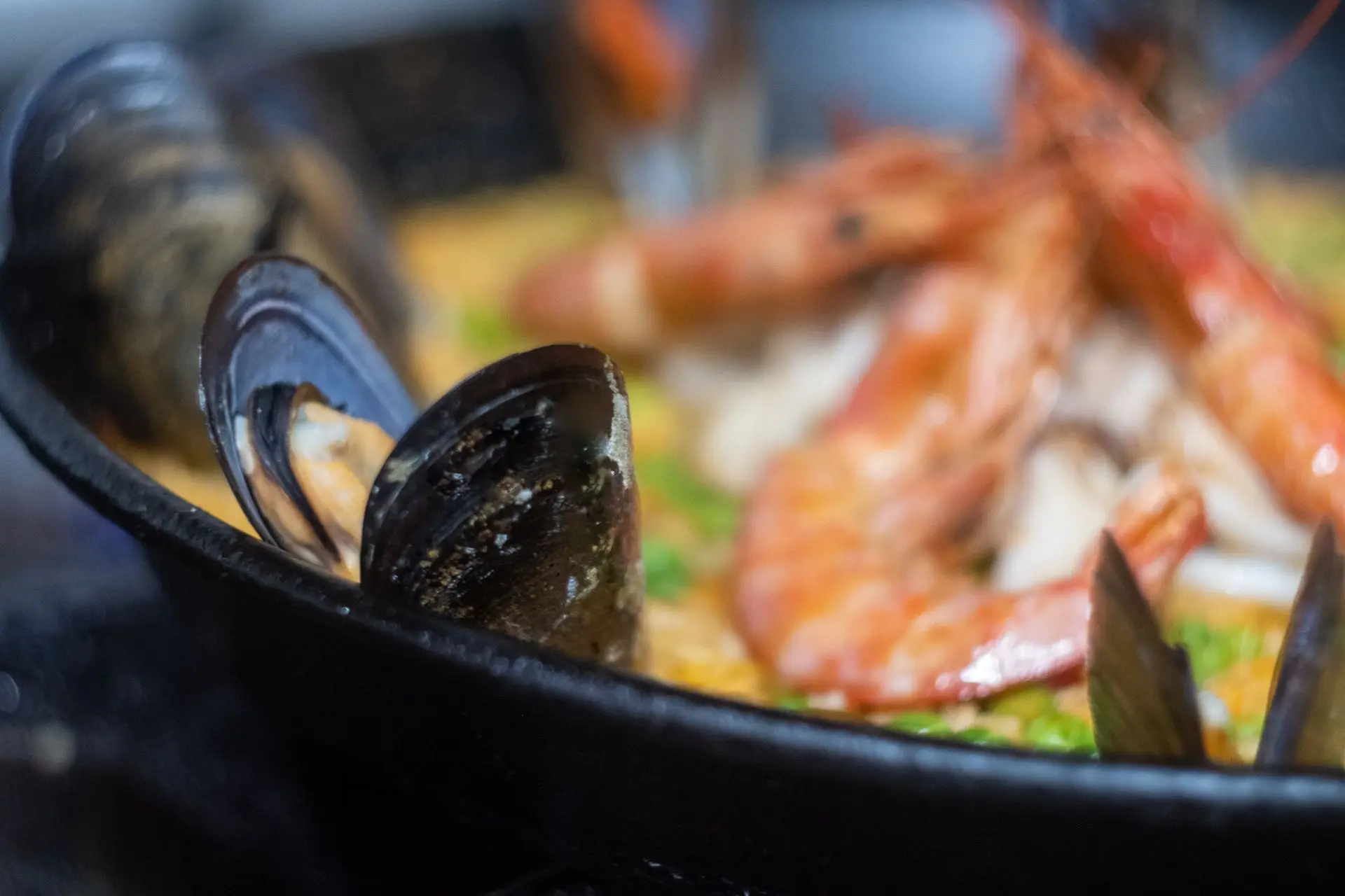 This vibrant close-up of a traditional Spanish paella showcases its rich textures and bold flavors, with perfectly cooked seafood, saffron-infused rice, and fresh herbs. Captured by Louis Mas, a food photographer and videographer in Barcelona, this image is ideal for digital marketing, restaurant branding, and culinary storytelling.